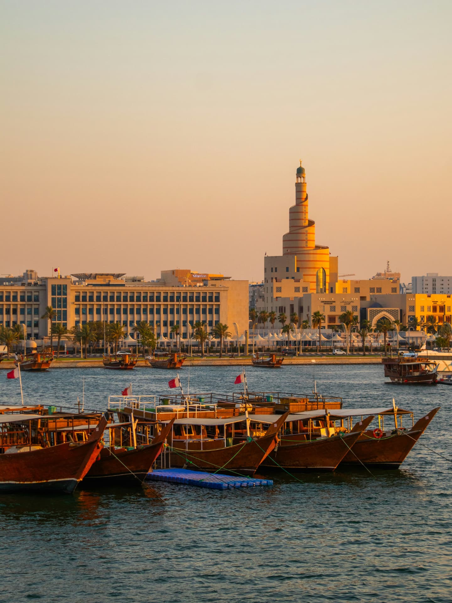 Traditional dhows on the Doha waterfront at sunset